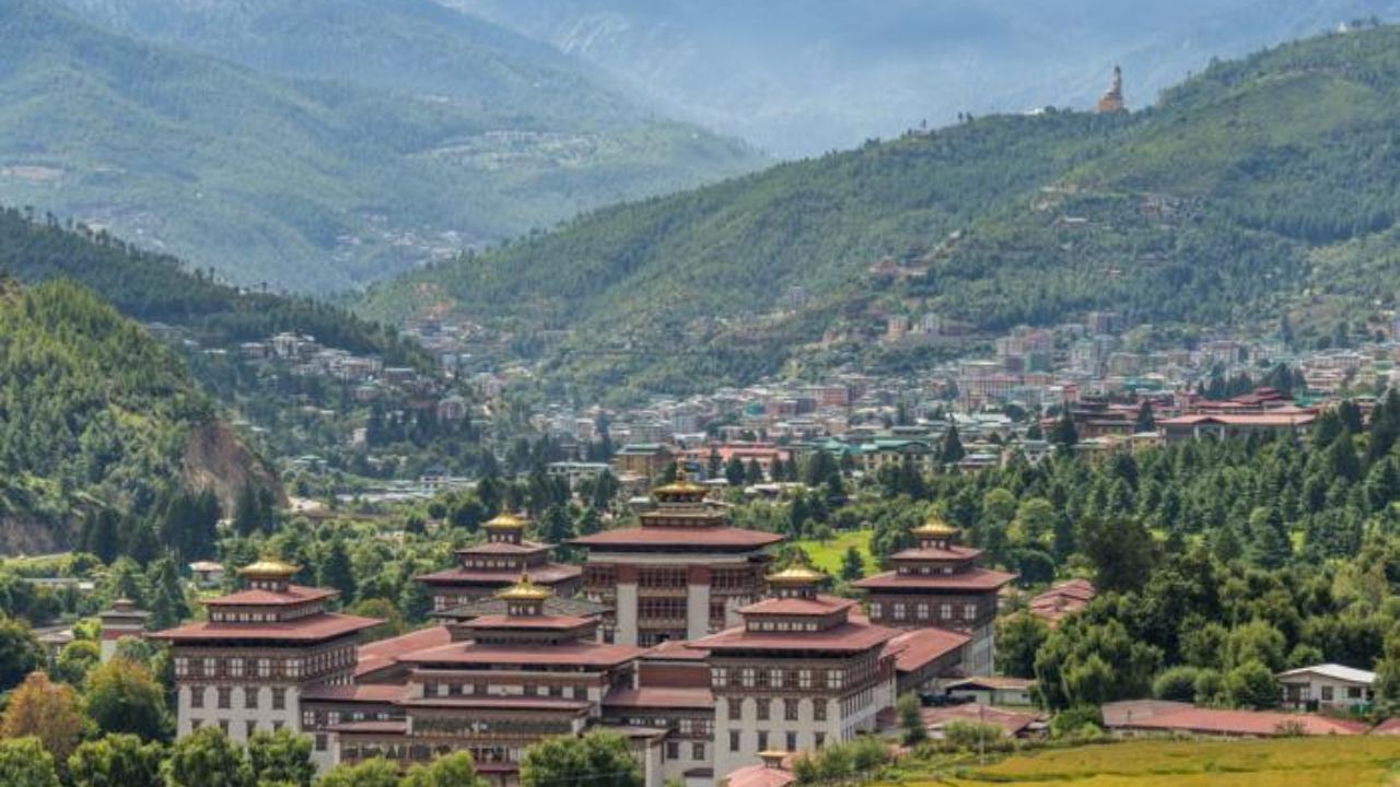 Thimphu city with traditional Bhutanese buildings, modern life, and mountains in the background