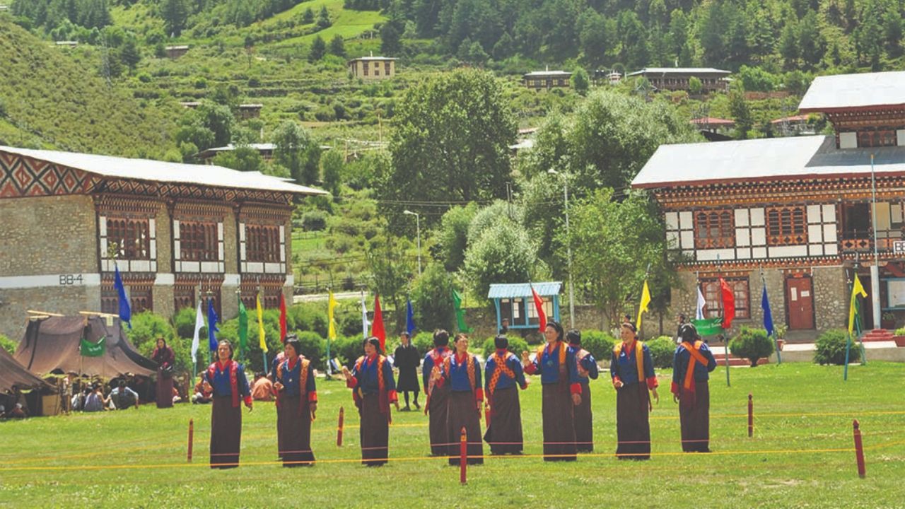 Locals celebrating the Haa Summer Festival in the scenic Haa Valley, surrounded by mountains and traditional Bhutanese culture