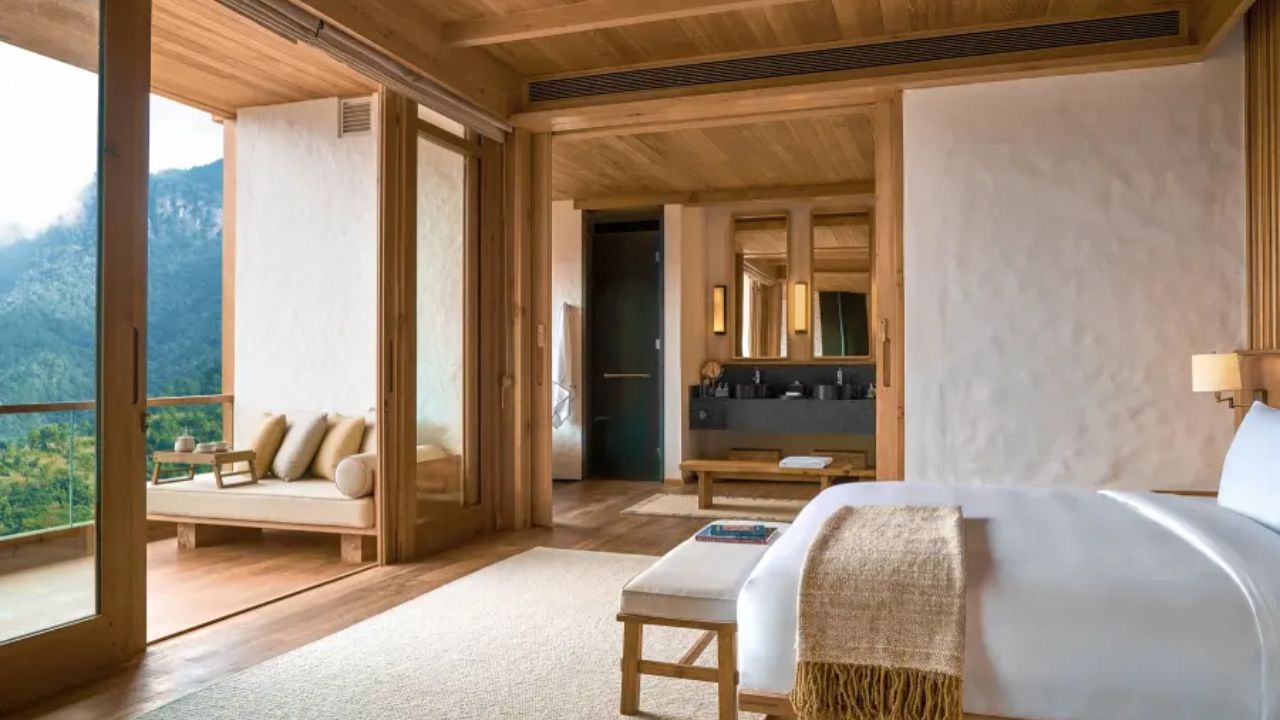 Six Senses Bhutan luxury lodge blending traditional Bhutanese architecture with modern comfort, set against forested mountains and serene Himalayan landscapes.