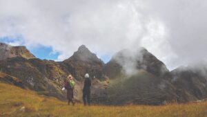 Bumthang trekkers in a misty mountain valley.